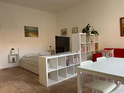 a living room with a bed and a television at Gens Julia in Rome