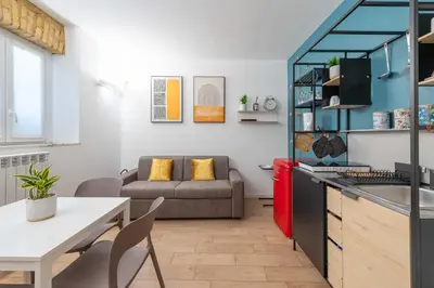 a kitchen and living room with a couch and a table at SuityRHome San Pietro 99 in Rome
