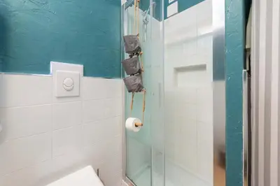 a bathroom with a shower with a glass door at SuityRHome San Pietro 99 in Rome