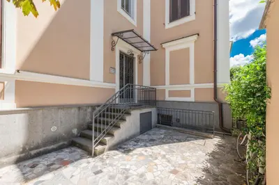a building with stairs leading to a door at SuityRHome San Pietro 99 in Rome