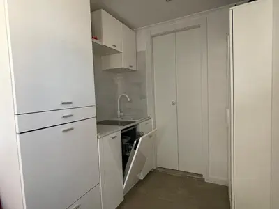 a kitchen with white cabinets and a sink at Little Aventino BnB in Rome