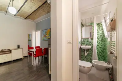 a bathroom with a white toilet and a sink at GuestHost - San Lorenzo Welcoming Apartment in Rome