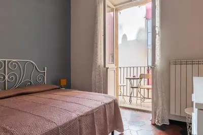 a bedroom with a bed and a balcony at GuestHost - San Lorenzo Welcoming Apartment in Rome