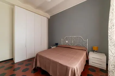 a bedroom with a bed and a white cabinet at GuestHost - San Lorenzo Welcoming Apartment in Rome