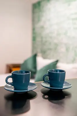 two blue coffee cups sitting on a table at Studio Suite Aurelia Antica in Rome