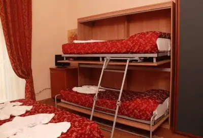 a room with three bunk beds in a room at Alloggio Turistico in Rome