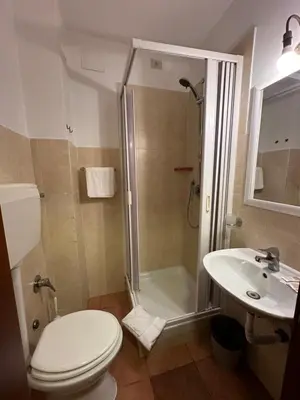 a bathroom with a shower and a toilet and a sink at Alloggio Turistico in Rome