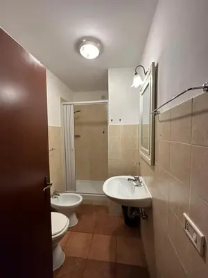 a bathroom with two sinks and a toilet and a mirror at Alloggio Turistico in Rome