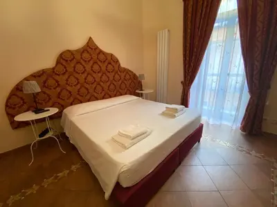 a bedroom with a bed with two towels on it at Alloggio Turistico in Rome