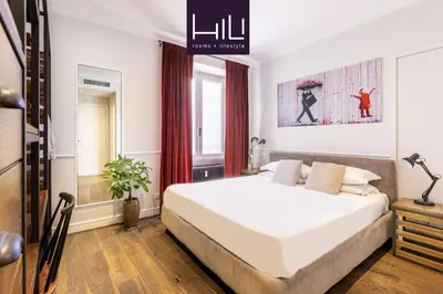 a bedroom with a large white bed in a room at Alla Corte Guest House by Hili in Rome