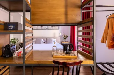 a room with a bed and a desk in a room with a bunk bed at Alla Corte Guest House by Hili in Rome