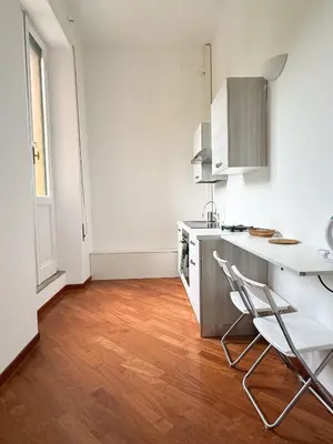 a kitchen with a table and chairs in a room at Montezebio Boutique Apartment in Rome