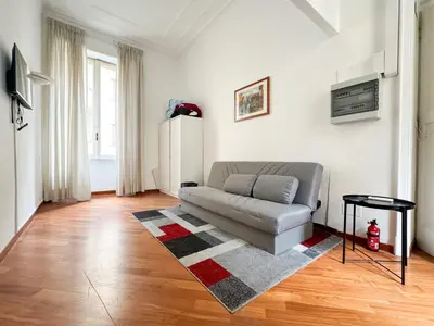 a living room with a couch and a rug at Montezebio Boutique Apartment in Rome