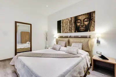 a bedroom with a large bed and a mirror at Relais Colonna in Rome