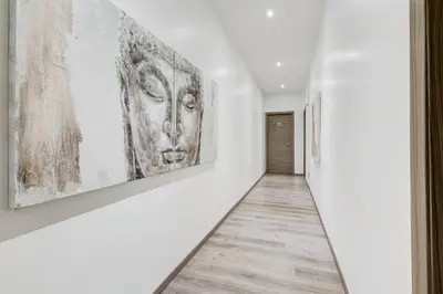 a hallway with two large artworks on the walls at Relais Colonna in Rome