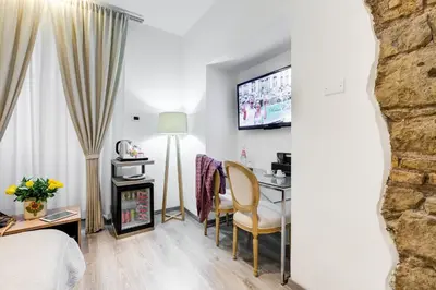 a hotel room with a bed and a table and chairs at Relais Colonna in Rome