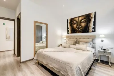 a bedroom with a large bed and a large mirror at Relais Colonna in Rome