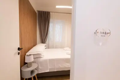 a bedroom with a white bed and a window at Domus Vatican Holiday in Rome