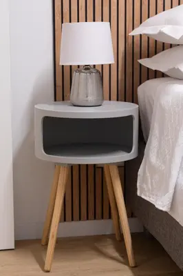 a side table with a lamp on it next to a bed at Domus Vatican Holiday in Rome