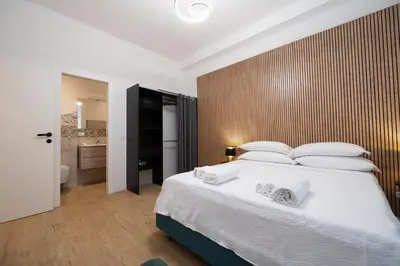 a bedroom with a large bed with white pillows at Domus Vatican Holiday in Rome