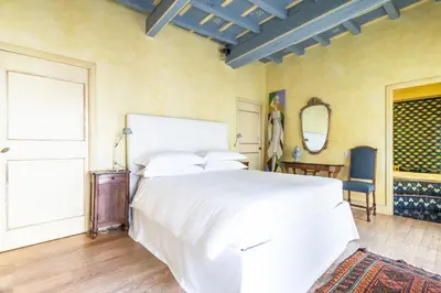 a bedroom with a white bed and a window at Suite Palazzo Bonaventura in Rome