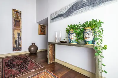 a living room with two vases on a table at Suite Palazzo Bonaventura in Rome