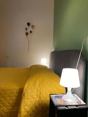 a bedroom with a bed and a table with a lamp at Domus Cornelia in Rome