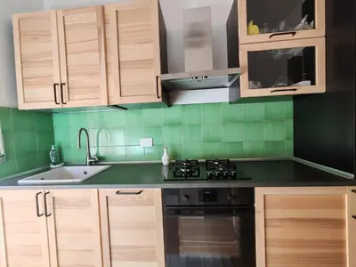 a kitchen with wooden cabinets and a sink and a stove at Domus Cornelia in Rome