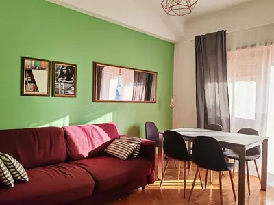 a living room with a red couch and a table at Domus Cornelia in Rome