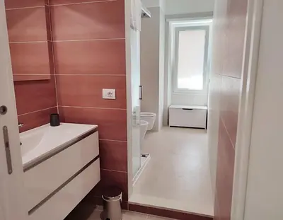 a bathroom with a white sink and a toilet at Have a nice stay in Rome in Rome