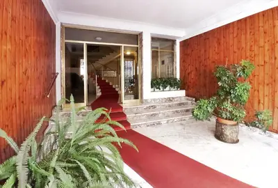 a lobby of a building with stairs and plants at Have a nice stay in Rome in Rome
