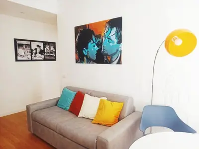 a living room with a couch with colorful pillows at Have a nice stay in Rome in Rome