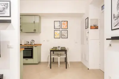 a small kitchen with a table and a counter at Domus76 Casa Vacanze in Rome