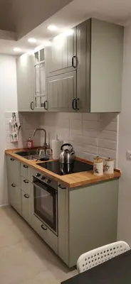 a kitchen with white cabinets and a stove top oven at Domus76 Casa Vacanze in Rome