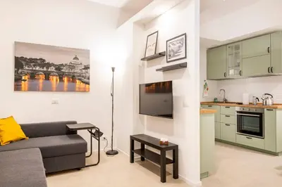 a living room with a couch and a kitchen at Domus76 Casa Vacanze in Rome
