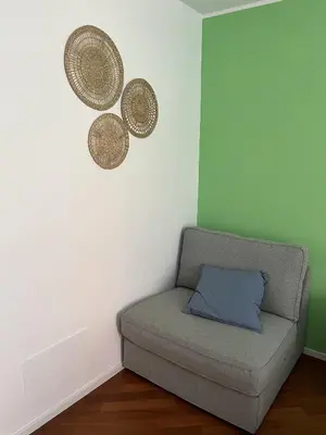 a room with a couch and two baskets on the wall at Domus76 Casa Vacanze in Rome