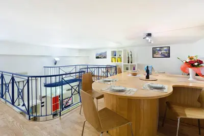 a dining room with a wooden table and chairs at Vatican Holiday Home in Rome