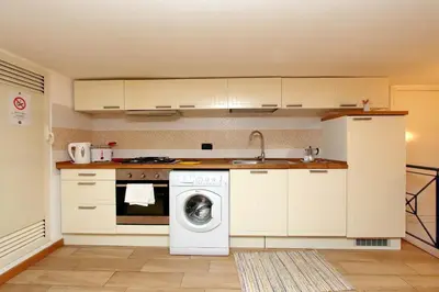 a kitchen with a washing machine and a washer at Vatican Holiday Home in Rome