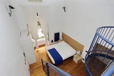 a small bedroom with a bed and a window at Vatican Holiday Home in Rome