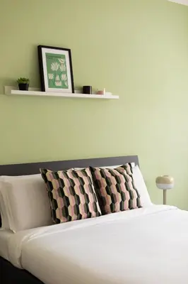 a white bed with two pillows on top of it at Domiziano Boutique Apartment in Rome