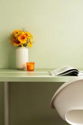 a vase of flowers on a table with a book at Domiziano Boutique Apartment in Rome