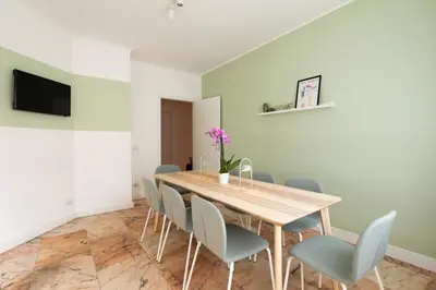 a dining room with a wooden table and chairs at Domiziano Boutique Apartment in Rome