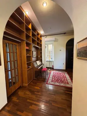 an archway in a room with a living room at Colosseum's Custodian - Apartment 115 m2 in Rome