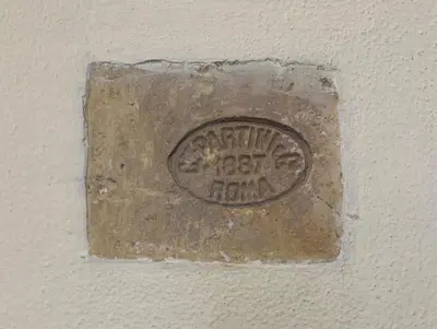 a metal plaque on a wall with the words congratulations happy hour at Colosseum's Custodian - Apartment 115 m2 in Rome
