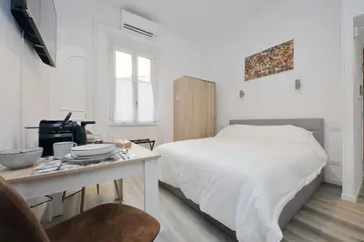 a bedroom with a bed and a desk with a computer at suity I cozy barberini studio in Rome