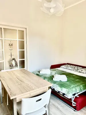a room with a bed and a wooden table at Casa Minerva a Testaccio in Rome