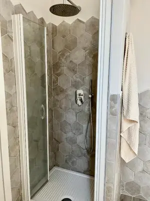 a shower with a glass door in a bathroom at Casa Minerva a Testaccio in Rome