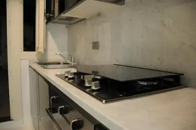a kitchen with a stove and a counter top at White Style Gambero in Rome