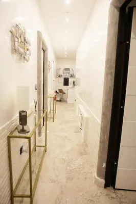 a hallway with white walls and a marble floor at Jadore Monic in Rome