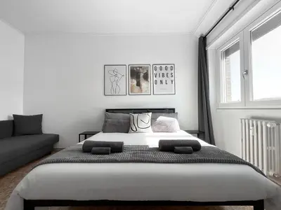 a white bedroom with a large bed and a couch at Horizon - Concept Apartment in Rome